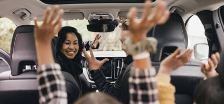 Family enjoying a car ride.