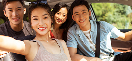 friends smiling inside a car