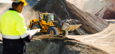 Construction worker looks over worksite