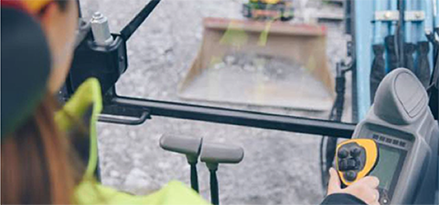 Construction equipment operator inside cab of excavator