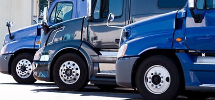 Three blue trucks