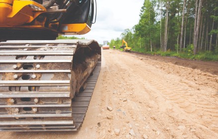 Close up on excavator track on dirt road