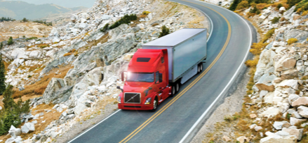 tractor trailer driving on mountain road