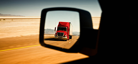 red truck in rear view mirror on highway