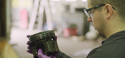 technician analyzing part of truck part