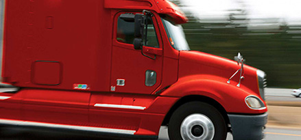 Truck with red cab in motion on the highway