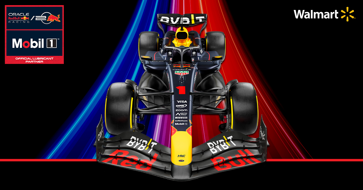 Oracle Red Bull racing car on top of bright blue and red light beams. 