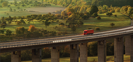 Semi truck driving across a bridge