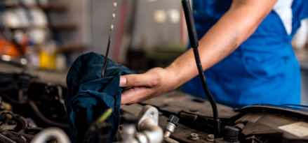 mechanic checking engine oil